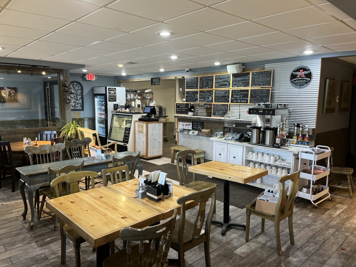 Cozy, rustic wooden tables and chairs in the small, 28-seat dining area of Miss Daisy's, WI.