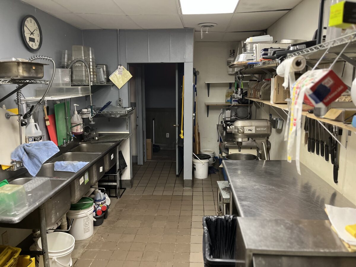 The dishwashing and sink station area with a large mixer in the back of Miss Daisy's kitchen.